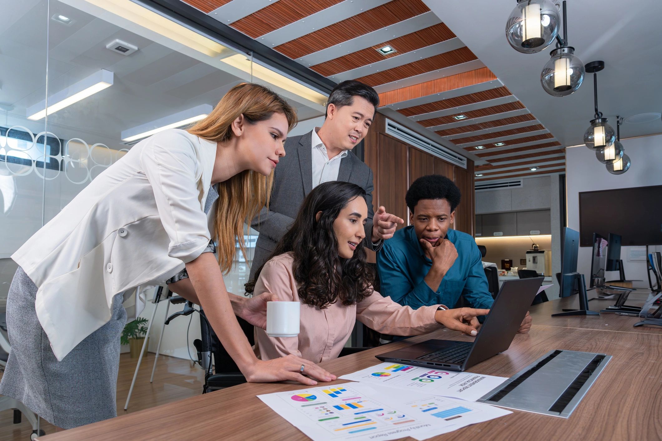 Finance professionals reviewing reports together in a meeting room